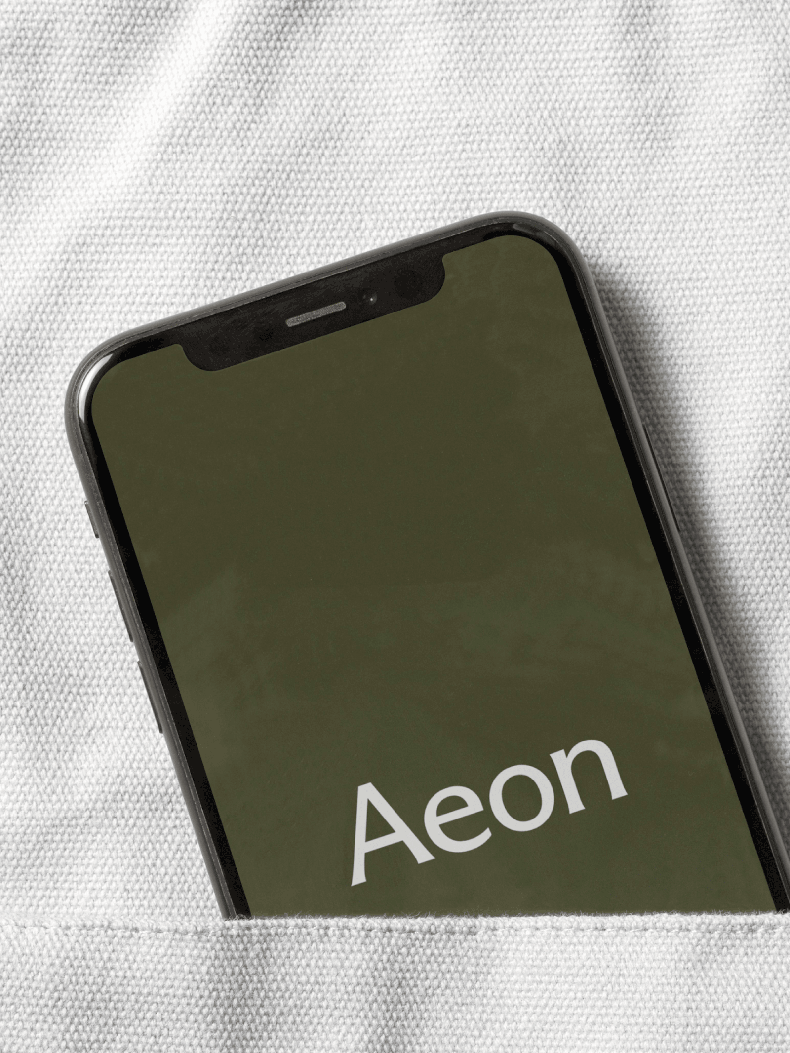 A close-up image of a white lab coat, shows the AEON logotype